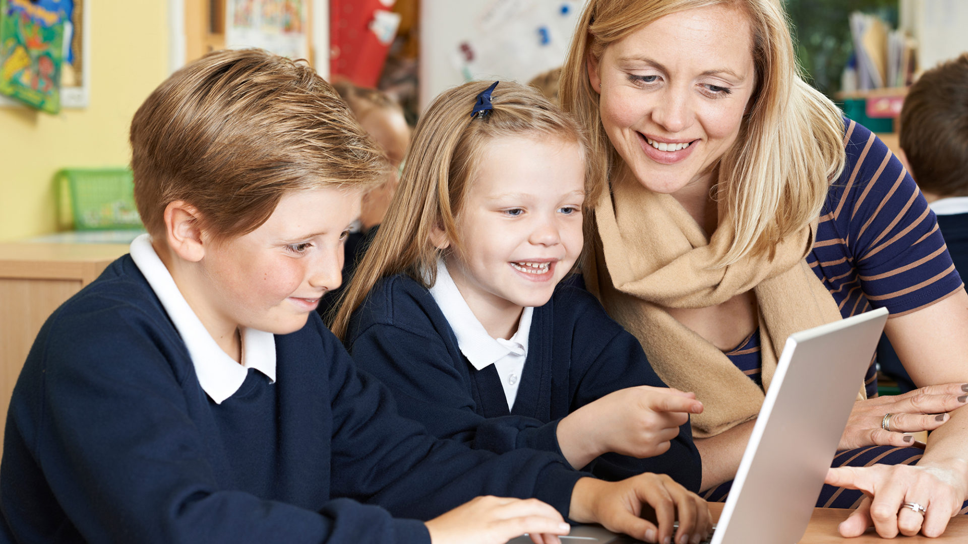 Teacher helping student with digital learning